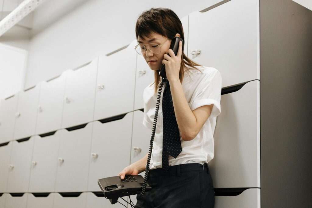 Small business owner using a phone answering service after business hours