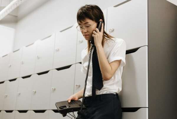 Small business owner using a phone answering service after business hours