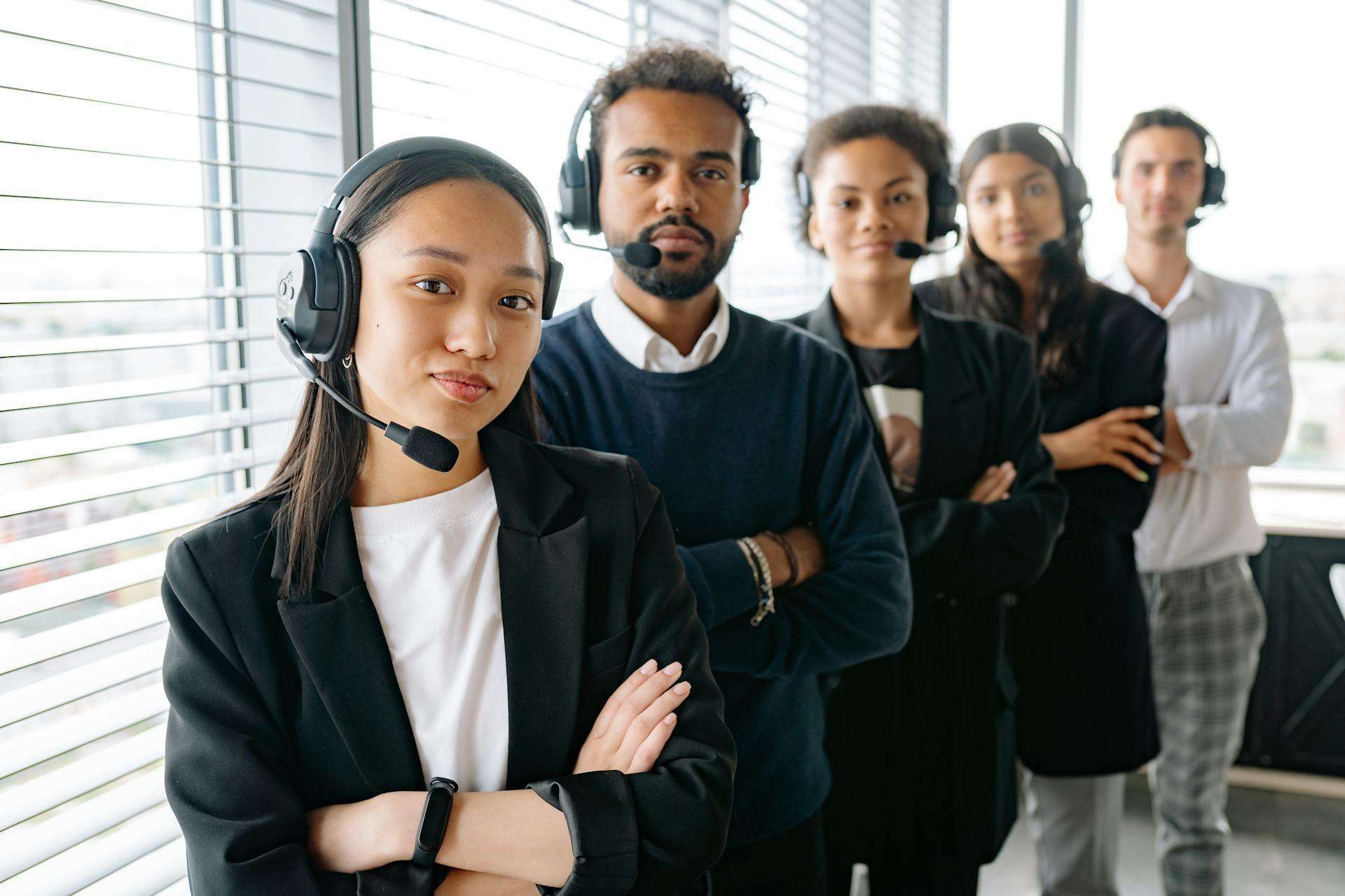 Contact center team wearing headsets in a modern office