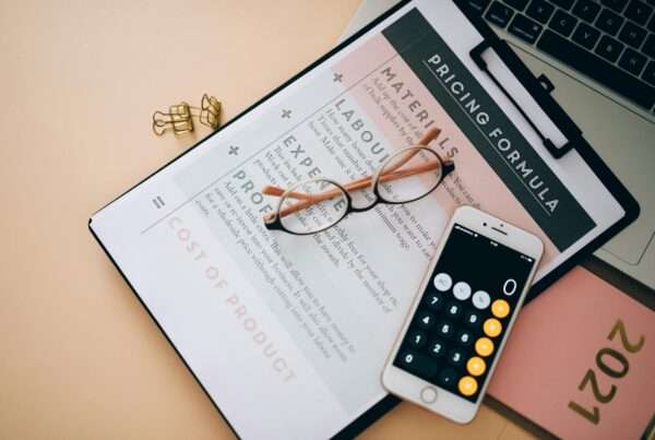 AI Phone Agent Pricing Models: What Businesses Actually Pay in 2026 5 Business pricing analysis documents and phone on a desk representing AI phone agent pricing models