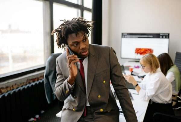 Business professional talking on phone in office setting representing business phone system comparison