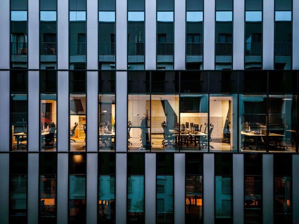 How Cytranet Delivers Building-Wide Internet and Wi-Fi to Multi-Tenant Office Buildings — Turning Connectivity Into a Revenue Stream and Competitive Advantage for Commercial Property Owners 11 Modern glass commercial office building with illuminated tenant offices representing building-wide Wi-Fi and internet connectivity for multi-tenant commercial properties