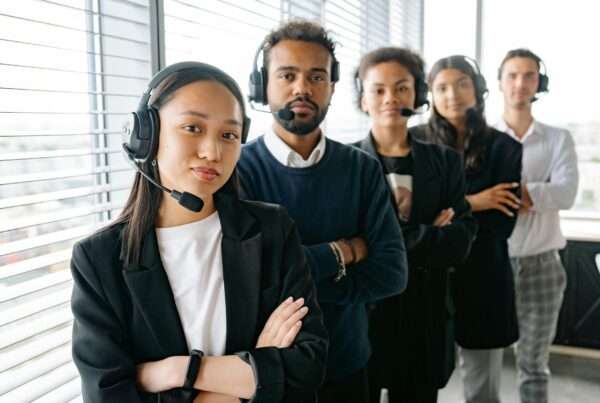 Contact center agents working with headsets, representing modern contact center software platforms