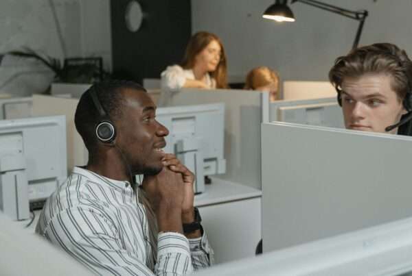 Call center team with headsets collaborating to deliver excellent customer service