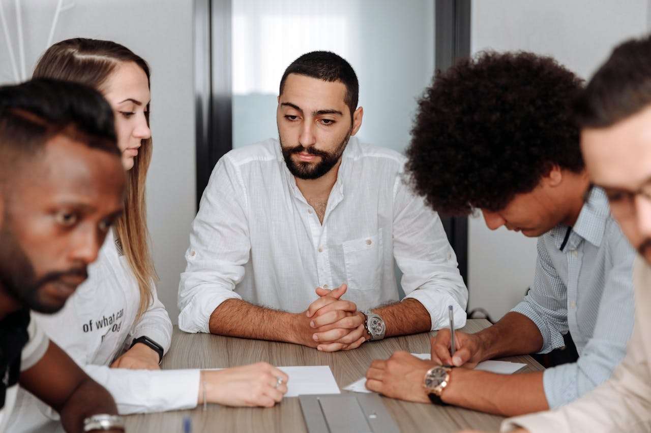A diverse team of business professionals collaborating in an office meeting