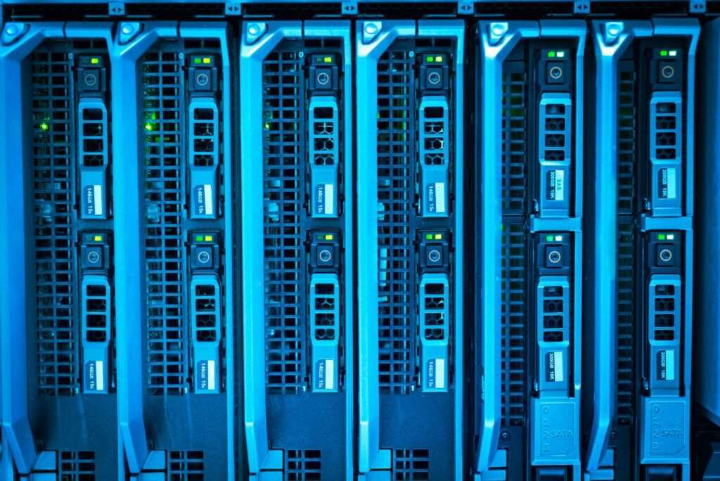 Illuminated server racks in a modern data center, representing AI-driven network security monitoring for regional telecom and enterprise clients