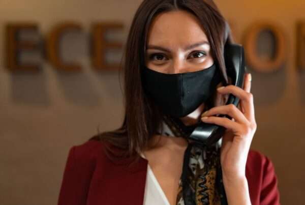 Professional receptionist at a desk representing AI phone answering and virtual receptionist capabilities for small businesses
