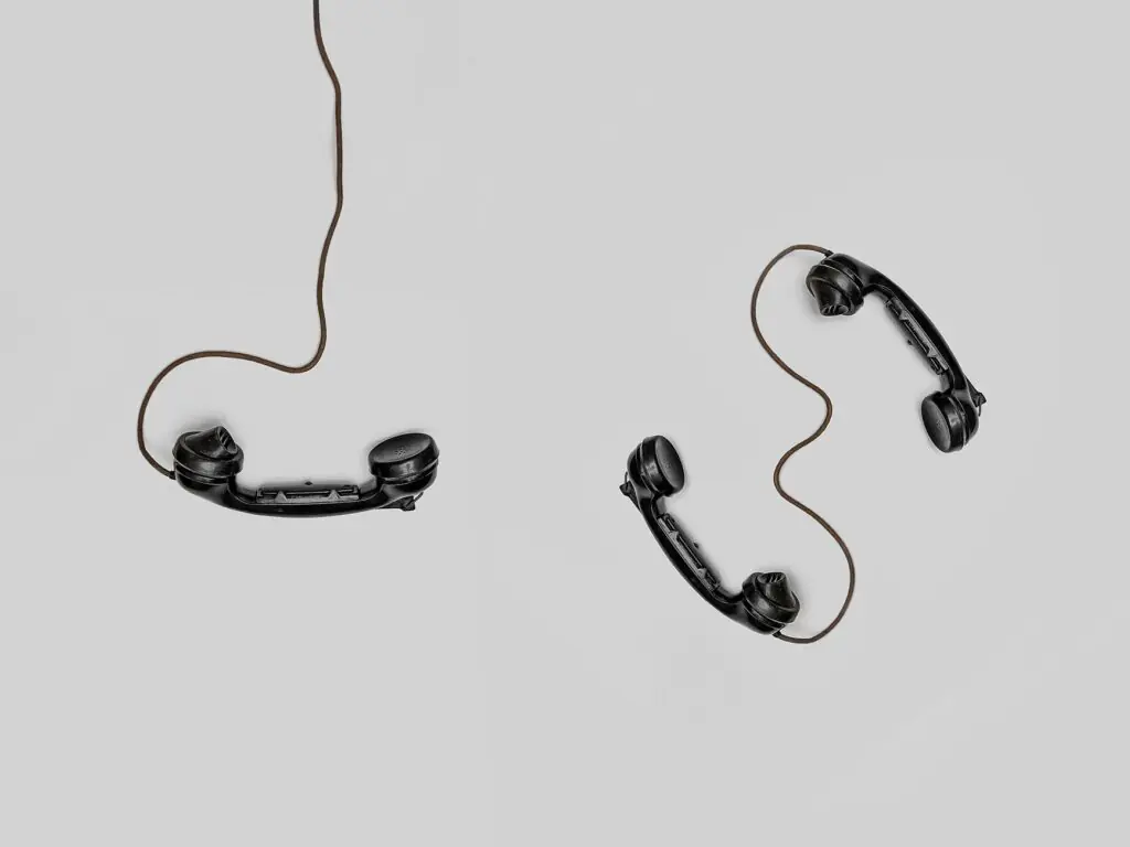 Two vintage telephone handsets illustrating a business phone tree and call routing system for offices