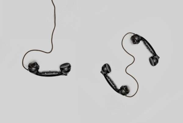 Two vintage telephone handsets illustrating a business phone tree and call routing system for offices