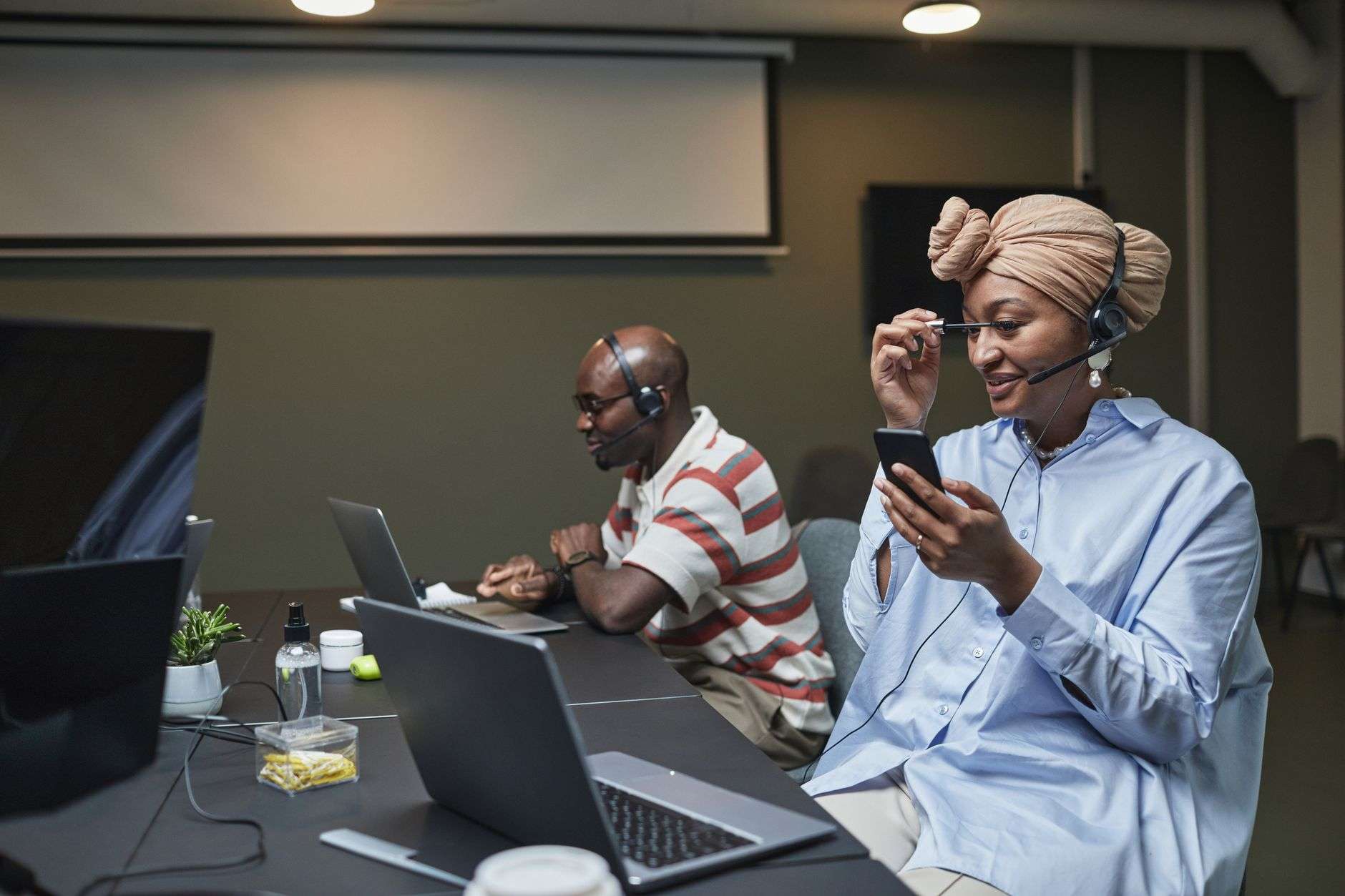 Professional call center agents with headsets and laptops migrating from legacy telephony to a cloud-based CRM communications platform