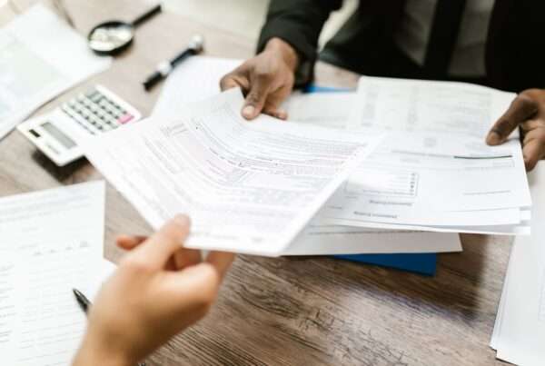 Business owner reviewing insurance policy documents at a desk