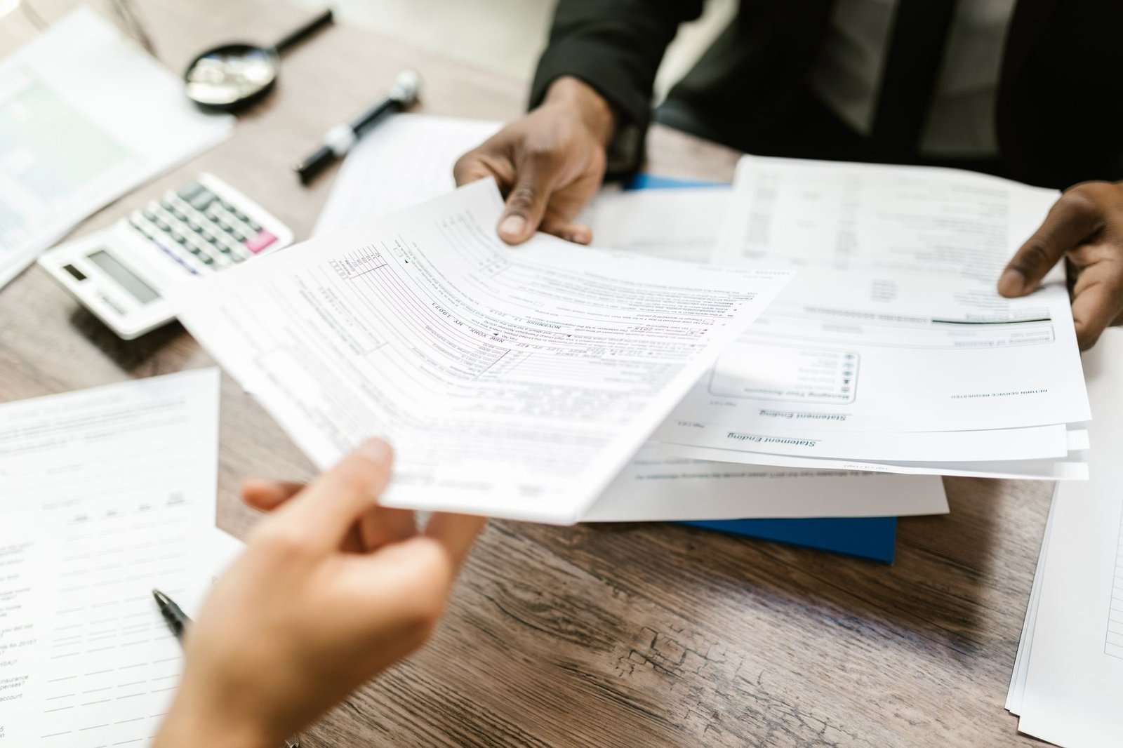 Why Cyber Insurance Alone Isn't Enough: What SMBs Need to Know About Coverage Limits and Prevention 5 Business owner reviewing insurance policy documents at a desk
