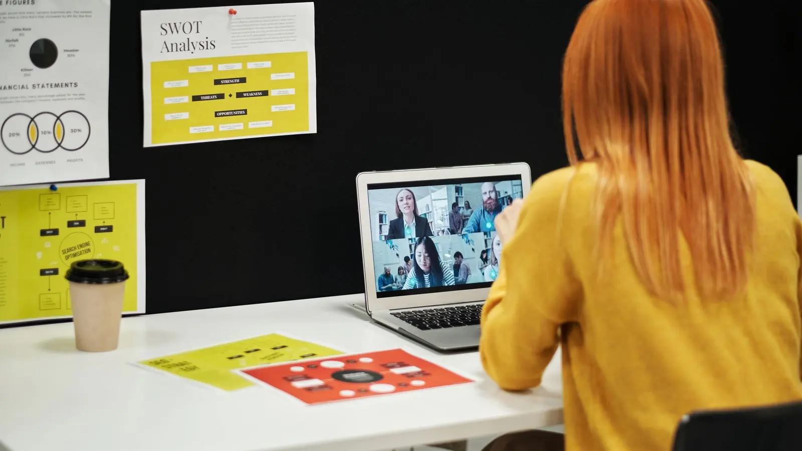 Professional conducting a virtual business meeting on a laptop using an AI-powered cloud VoIP phone system
