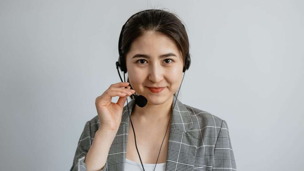 Business professional wearing a headset using an intelligent cloud phone system to manage customer calls