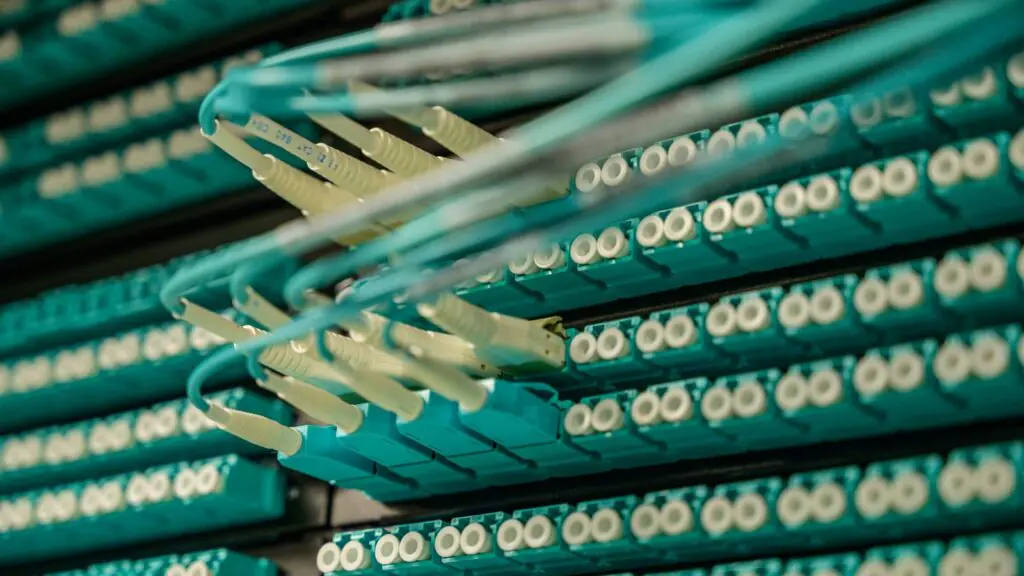 Fiber optic cables connected to a server rack representing high-capacity business network infrastructure