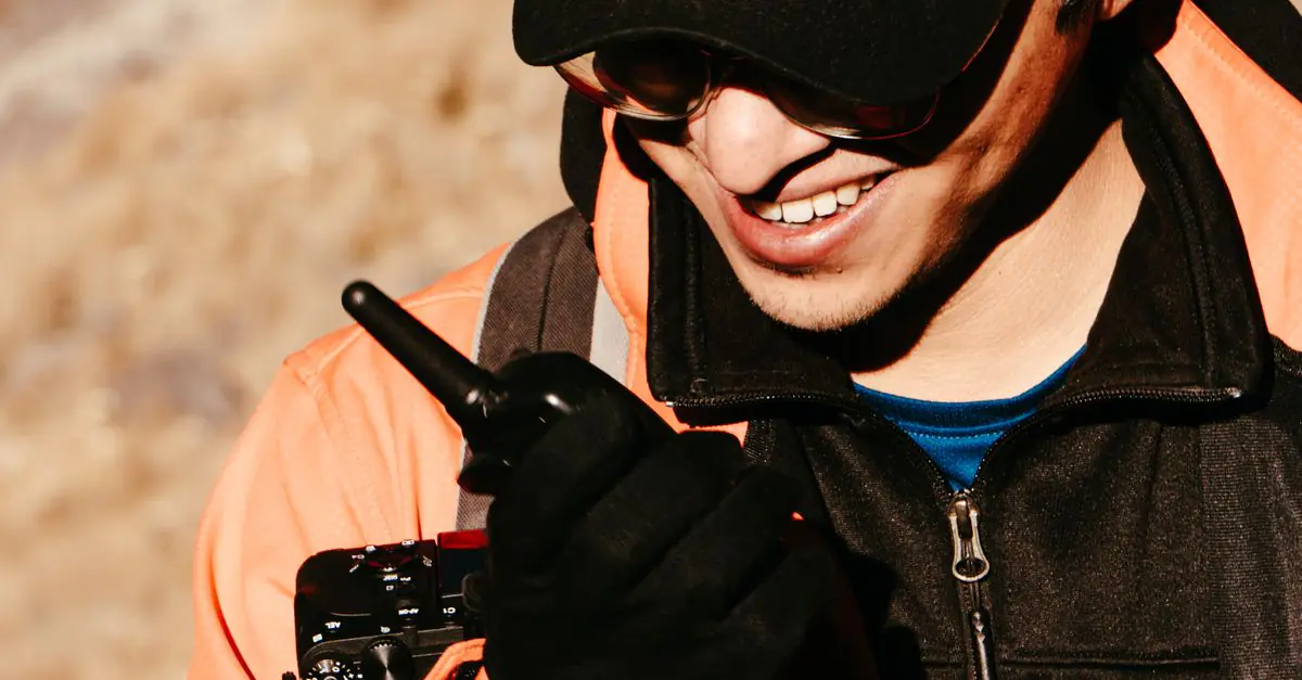 Field worker using a Motorola TLK push-to-talk two-way radio outdoors, supplied and supported by Cytranet in Las Vegas