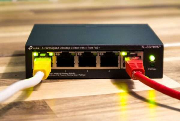 TP-Link Omada PoE network switch with connected Ethernet cables for managed business Wi-Fi