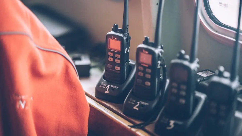 Fleet of professional digital two-way radios resting in charging stations, representing Cytranet's encrypted radio rental inventory for events in Las Vegas and Los Angeles