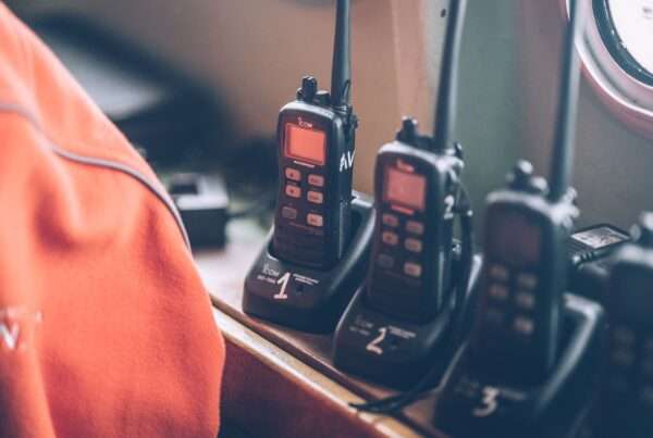 Fleet of professional digital two-way radios resting in charging stations, representing Cytranet's encrypted radio rental inventory for events in Las Vegas and Los Angeles