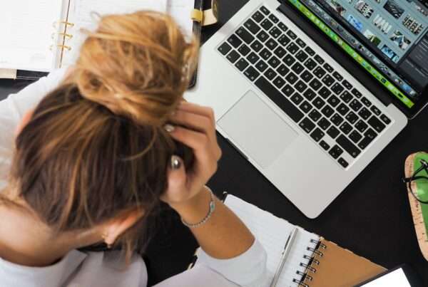 Small-business owner reviewing IT issues on a laptop