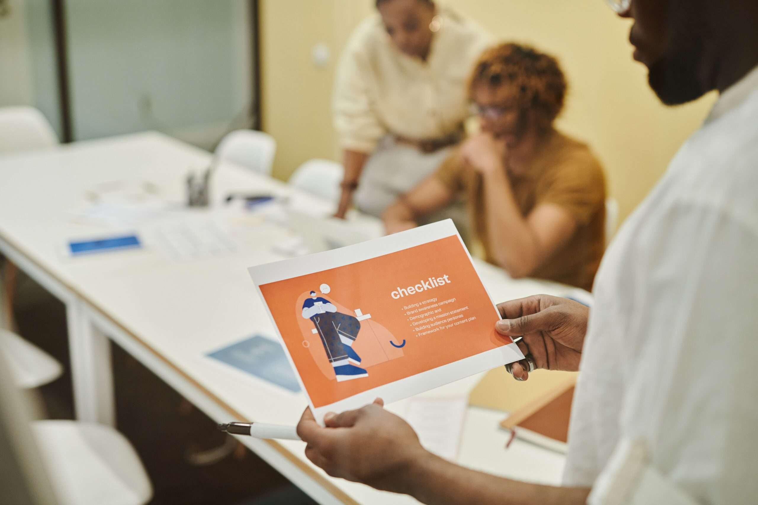 Why Business Continuity Plans Fail: 6 Mistakes Small Businesses Make 5 Colleagues reviewing a business continuity plan checklist together in a modern office setting