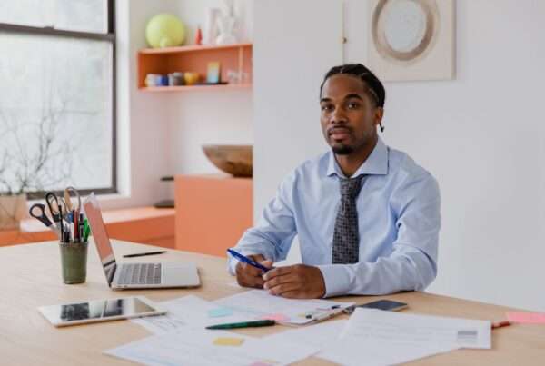 Best States to Start a Business in 2026: What the Rankings Really Tell Founders 7 Small business owner sitting at a desk reviewing paperwork and a laptop while planning where to start a new company