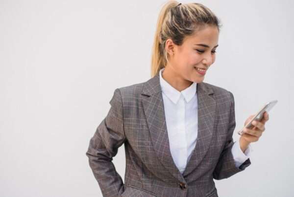 8 Features to Look for in a Business Text Messaging Solution in 2026 4 Business professional reviewing a text messaging conversation on a smartphone