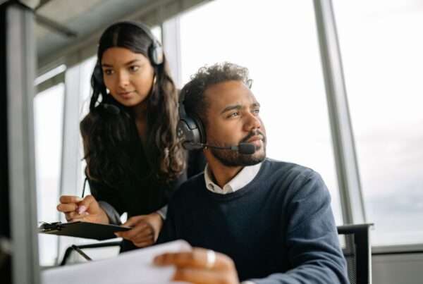 Real-Time Call Context: How Better Systems Help Teams Deliver Faster Customer Service 9 Customer service professionals using headsets at workstations