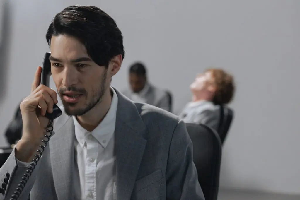 Business professional using a modern cloud-based business phone system in an office