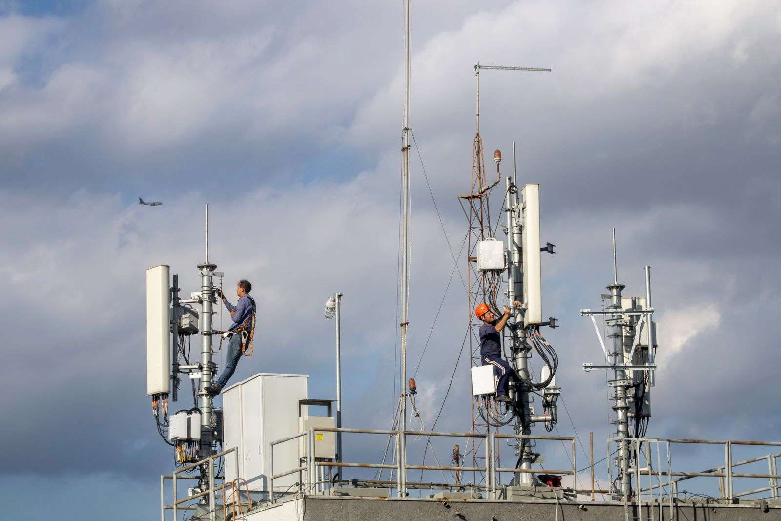 Two telecom technicians working on a communications tower, representing the skilled jobs behind Cytranet's fiber and wireless network infrastructure across Nevada, Arizona, and California