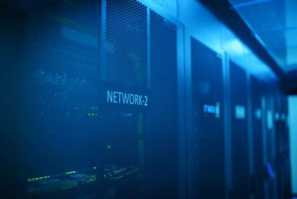 Rows of illuminated network servers in a modern data center, representing the IT infrastructure municipalities and businesses must secure against cyberattacks
