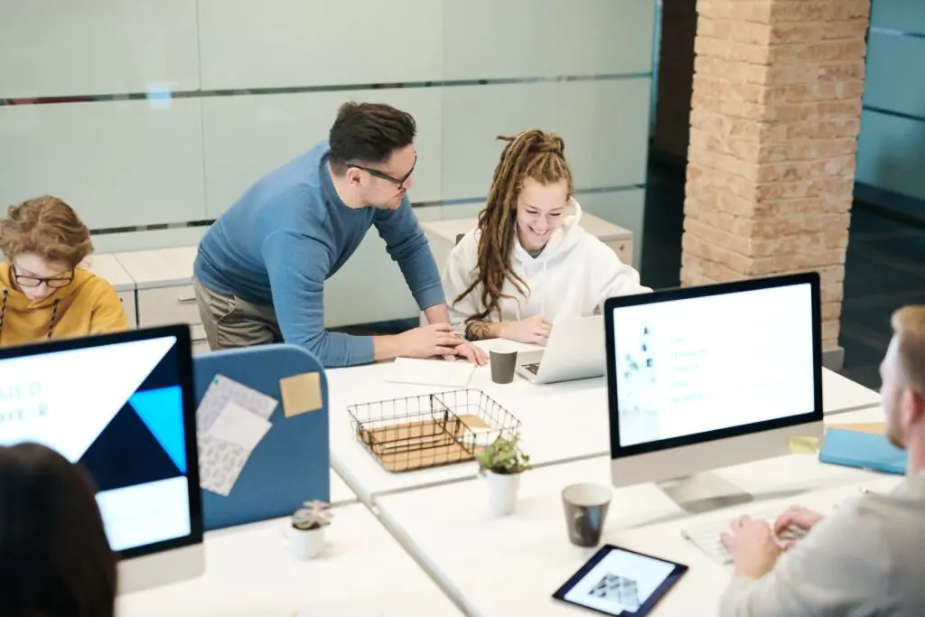 Small business employees working on laptops in an office