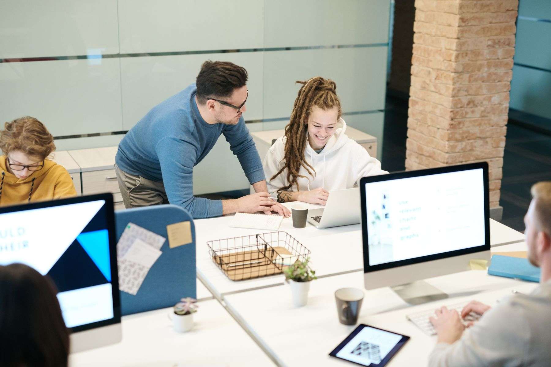 AI Tools for Small Business: 5 Best Practices Before You Adopt 3 Small business employees working on laptops in an office