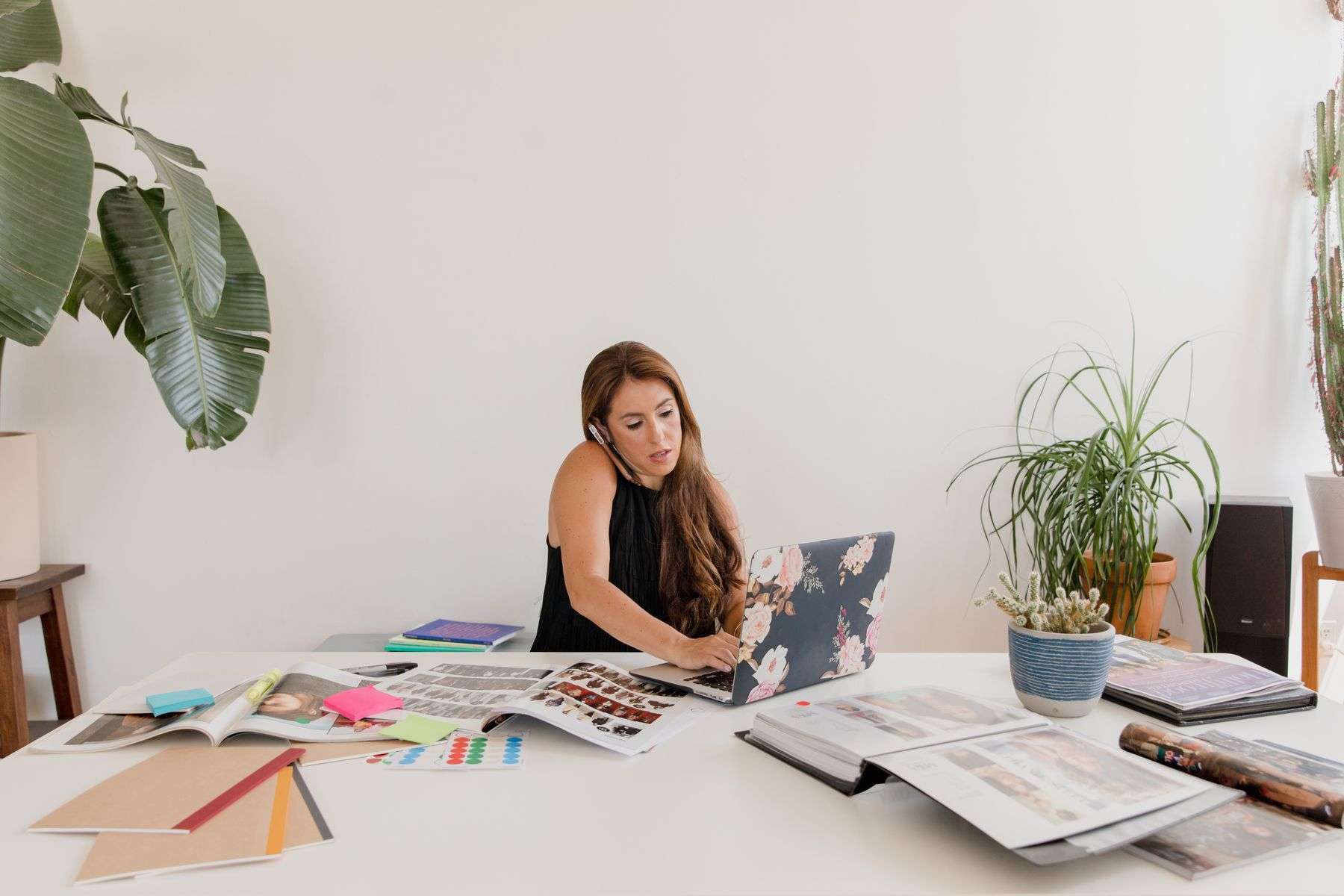 Best VoIP Phone Systems for Small Businesses in 2026, Compared 6 Small business owner working at a desk with a phone and laptop