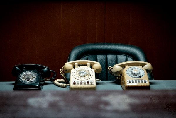 Desk phone on an office workstation configured so that employees can dial 911 directly and send an accurate dispatchable location