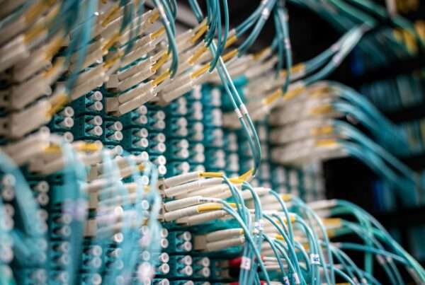 Fiber optic switch with multiple connected cables transmitting high speed data across a business network backbone