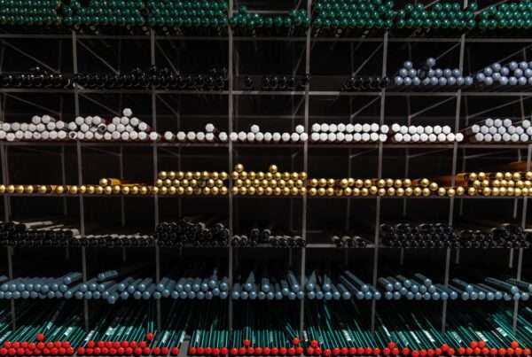 Row of labeled business laptops and network equipment on an office shelf, ready to be tracked in an IT asset inventory
