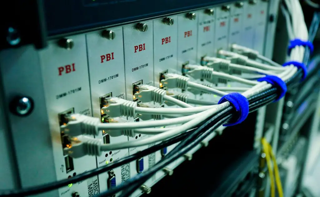 Ethernet cables connected to a network switch panel supporting business internet and VoIP failover