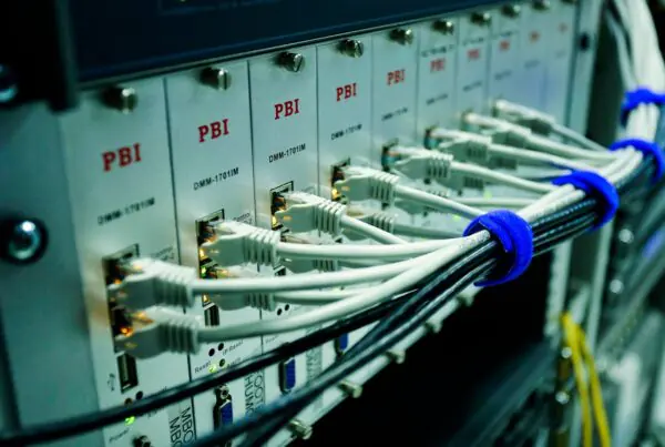 Ethernet cables connected to a network switch panel supporting business internet and VoIP failover