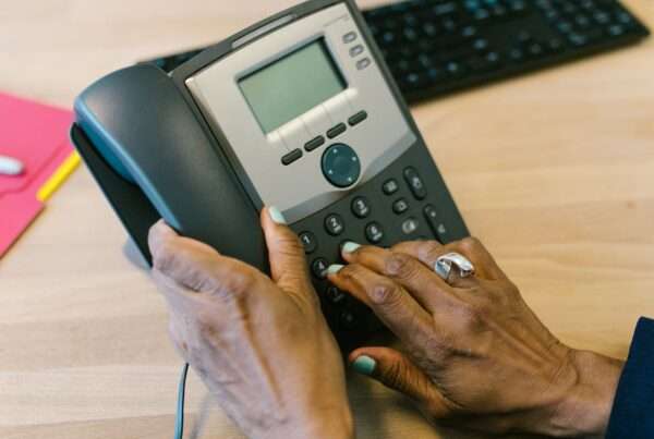 Business desk phone on an office desk representing the choice between PBX and VoIP phone systems