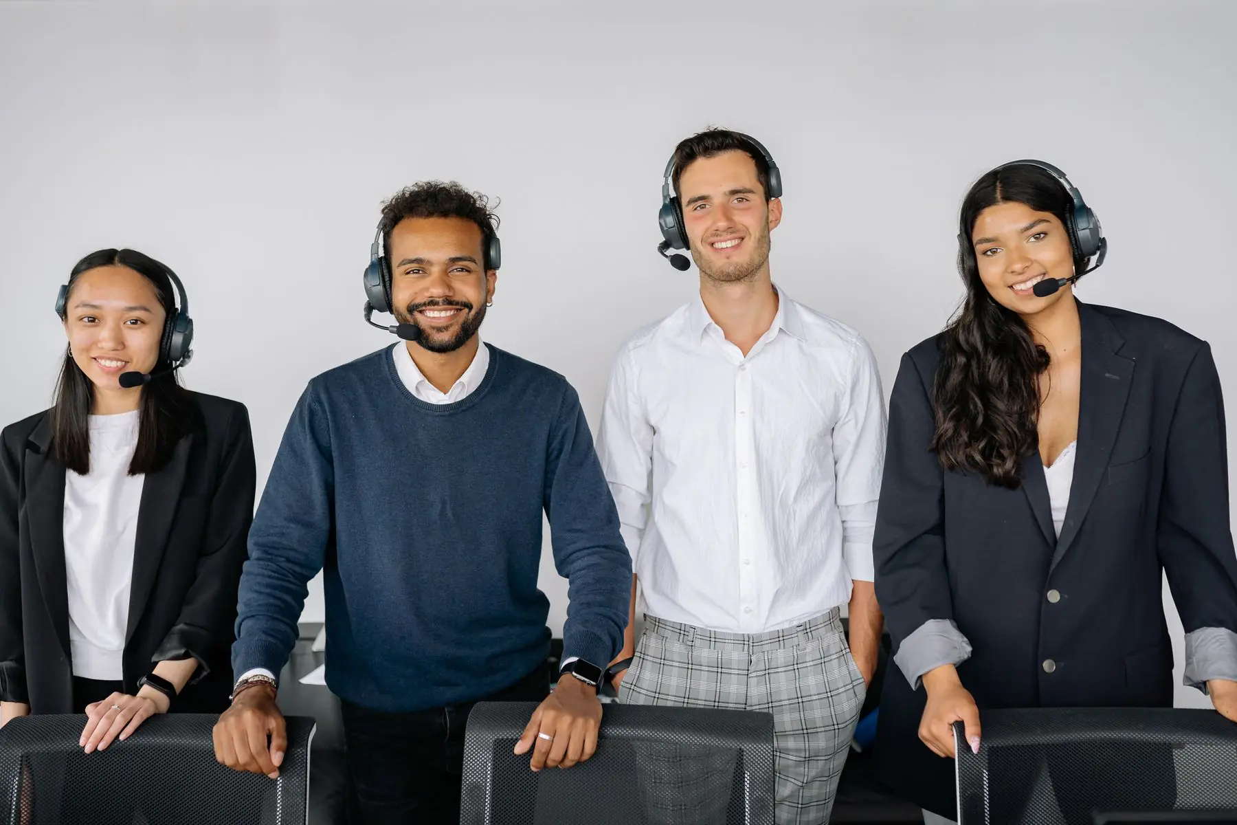 Business Phone System or Contact Center? A Decision Guide for Support Teams 7 Customer support agents working at desks with headsets and monitors