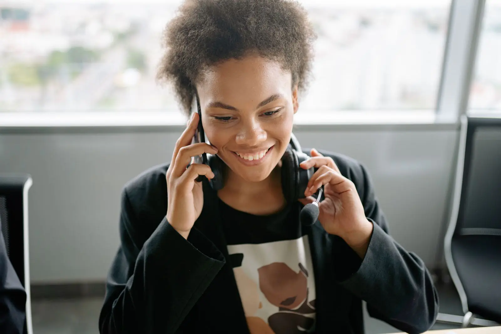 Auto Dialer Software: A Practical Guide for Outbound Teams 1 Smiling sales representative wearing a headset while speaking on the phone in an office
