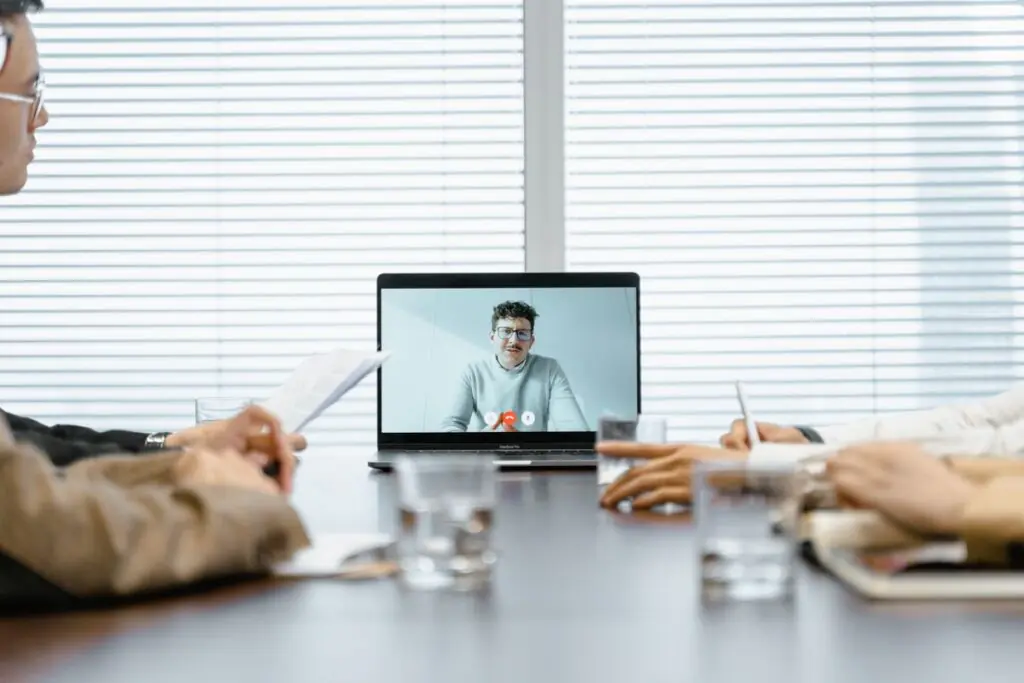 Diverse team of professionals participating in a virtual video meeting in a conference room