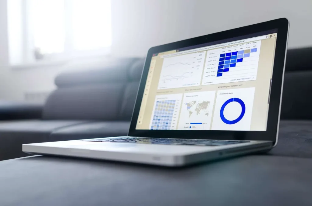 Laptop screen displaying data analytics graphs and charts, representing AI agent performance and ROI measurement