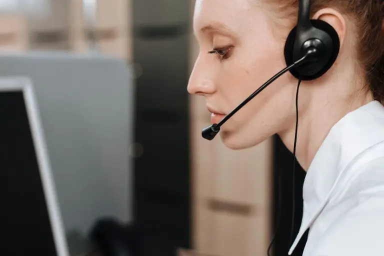 Front desk team member wearing a headset at her desk, representing AI receptionist call answering and pricing decisions