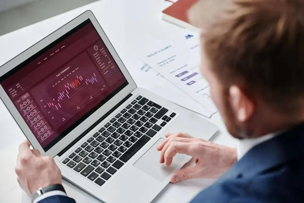 Business professional reviewing analytics dashboard and application strategy on laptop in modern office