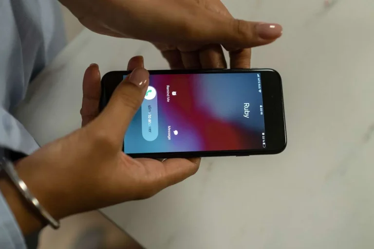Smartphone on a desk showing an incoming call screen, illustrating how legitimate business calls can be mislabeled as spam by carriers