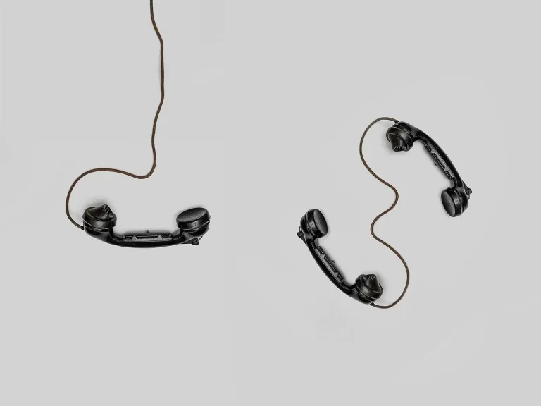Two vintage telephone handsets illustrating a business phone tree and call routing system for offices
