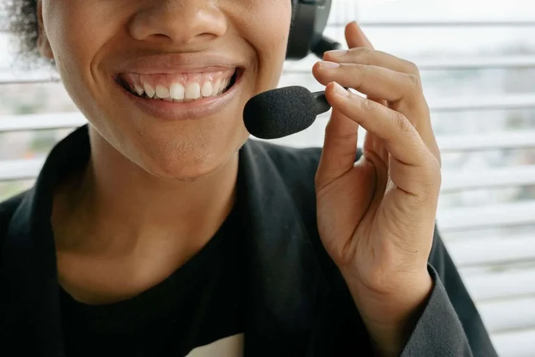 Customer service workstation with a headset and computer screen showing a call recording interface with playback controls and retention settings