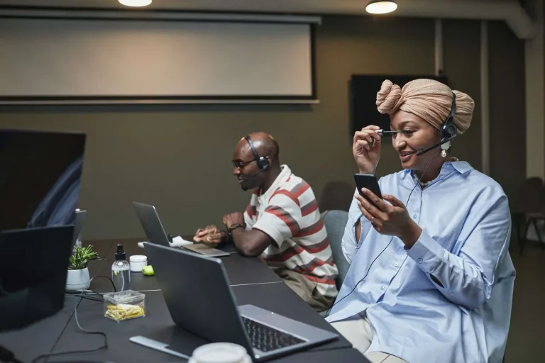 Professional call center agents with headsets and laptops migrating from legacy telephony to a cloud-based CRM communications platform